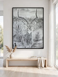 Golden Gaze in a black floating frame, shown in a modern white room